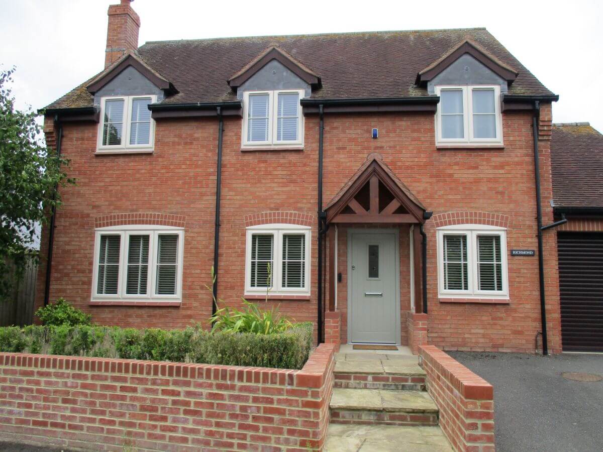 Cream PVCu windows with contrasting Sage Green door